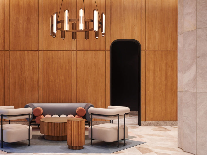Custom commercial lobby lighting by Shakúff — hand-blown glass fixture above a lounge seating area