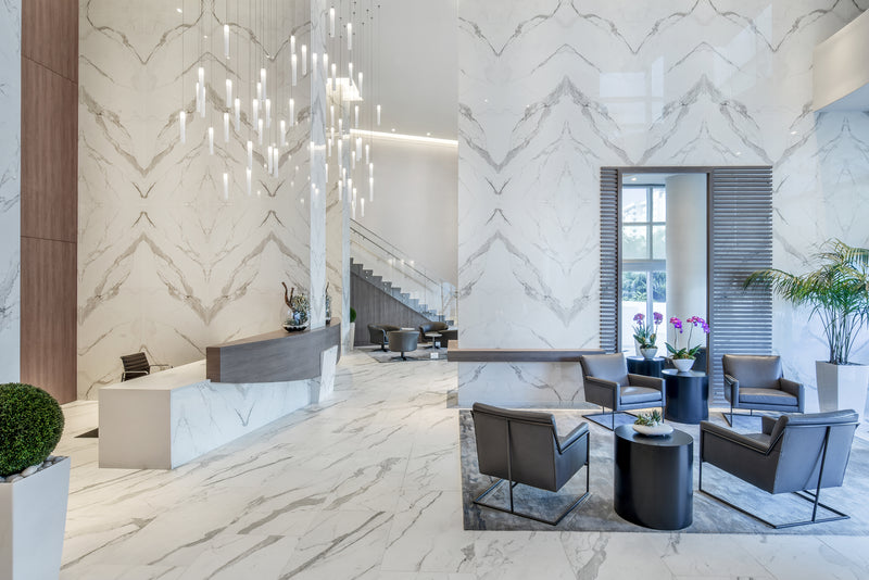 U-shaped White Candle chandelier and seven-foot matching sconces in a Miami residential lobby